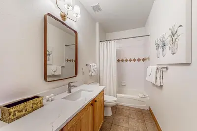 a bathroom with a sink and a toilet and a mirror at Blue River Grove in Silverthorne