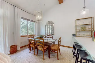 a dining room with a table and chairs at Blue River Grove in Silverthorne