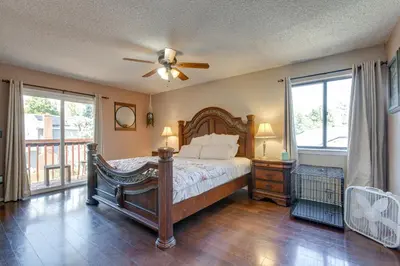 a bedroom with a bed and a ceiling fan at Spacious Aurora Retreat with Game Room and Hot Tub! in Aurora