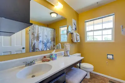 a bathroom with a sink and a toilet at Spacious Aurora Retreat with Game Room and Hot Tub! in Aurora