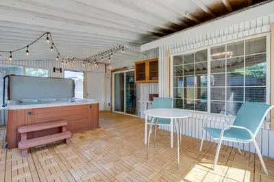 a kitchen with a table and chairs and a table and chairs at Spacious Aurora Retreat with Game Room and Hot Tub! in Aurora