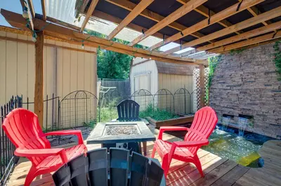 a patio with three chairs and a table and a pergola at Spacious Aurora Retreat with Game Room and Hot Tub! in Aurora