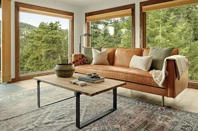 a living room with a couch and a coffee table at Stunning View House - 15-min to Town - Evergreen in Evergreen