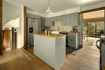 a kitchen with gray cabinets and a counter top at Stunning View House - 15-min to Town - Evergreen in Evergreen