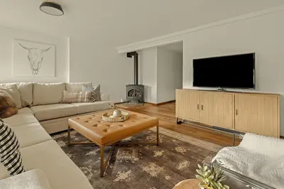 a living room with a couch and a flat screen tv at Stunning View House - 15-min to Town - Evergreen in Evergreen