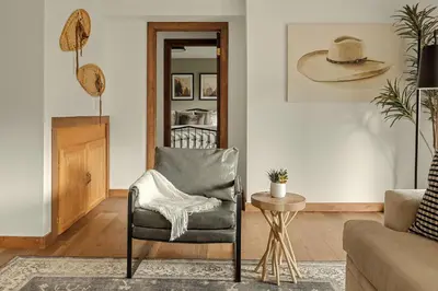 a living room with a chair and a table at Stunning View House - 15-min to Town - Evergreen in Evergreen