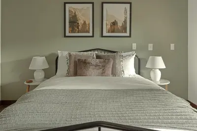 a bedroom with a bed with three pictures on the wall at Stunning View House - 15-min to Town - Evergreen in Evergreen