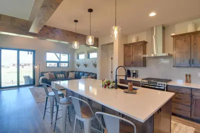 an open kitchen and living room with a large island at Colorado Home with Hot Tub! Close to Ski Resorts in Granby