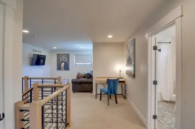 a hallway with a stairway leading to a living room at Colorado Home with Hot Tub! Close to Ski Resorts in Granby