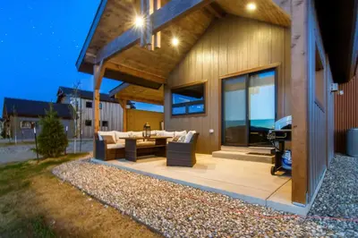 a house with a patio with a table and a grill at Colorado Home with Hot Tub! Close to Ski Resorts in Granby