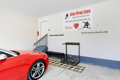 a red car parked in front of a garage at Colorado Home with Hot Tub! Close to Ski Resorts in Granby