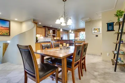 a dining room and kitchen with a wooden table and chairs at Furnished Deck and Fire Pit Thornton Family Retreat in Thornton
