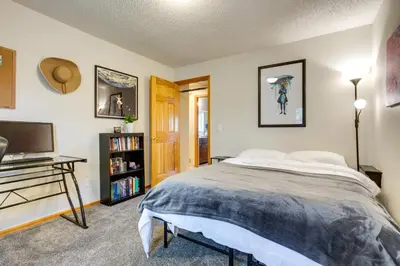 a bedroom with a bed and a desk and a television at Furnished Deck and Fire Pit Thornton Family Retreat in Thornton