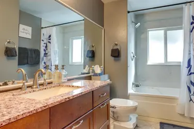 a bathroom with a sink and a toilet and a mirror at Furnished Deck and Fire Pit Thornton Family Retreat in Thornton