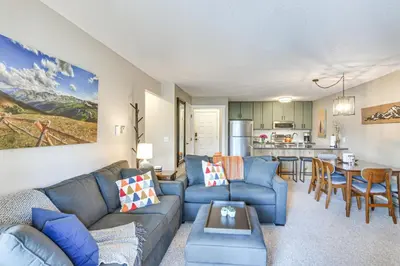 a living room with a couch and a table at Elevated Fraser Condo with Mountain View and Amenities in Fraser
