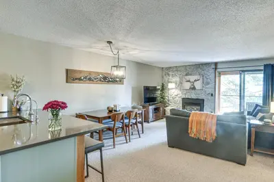 a living room with a kitchen and a dining room at Elevated Fraser Condo with Mountain View and Amenities in Fraser