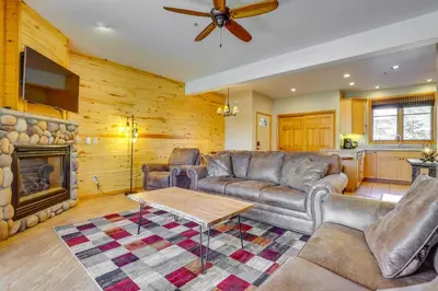 a living room with a couch and a fireplace at Walk to Main Street Grand Lake Condo with Patio in Grand Lake
