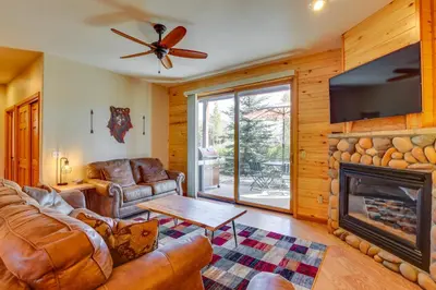 a living room with a couch and a fireplace at Walk to Main Street Grand Lake Condo with Patio in Grand Lake