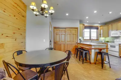a kitchen and dining room with a table and chairs at Walk to Main Street Grand Lake Condo with Patio in Grand Lake