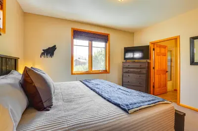 a bedroom with a bed and a television in it at Walk to Main Street Grand Lake Condo with Patio in Grand Lake