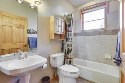 a bathroom with a white toilet and a sink at Walk to Main Street Grand Lake Condo with Patio in Grand Lake