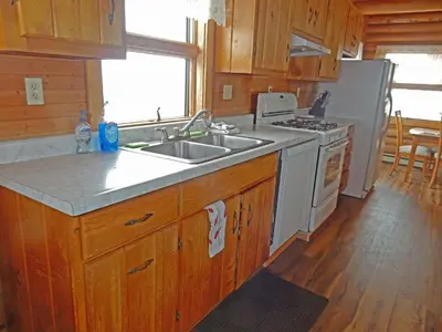 a kitchen with a sink and a stove at Wapiti Retreat at 22 West Cabins and Recreation in Walden