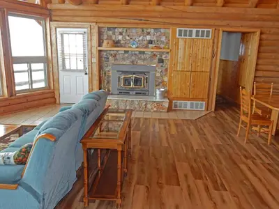 a living room with a blue couch and a fireplace at Wapiti Retreat at 22 West Cabins and Recreation in Walden