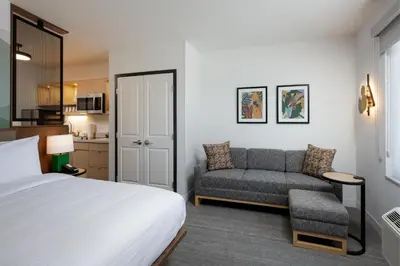 a hotel room with a bed and a couch at TownePlace Suites by Marriott Denver North Thornton in Thornton