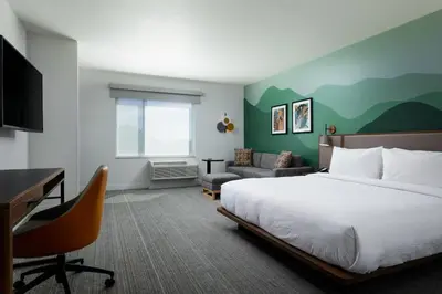 a hotel room with a bed and a desk at TownePlace Suites by Marriott Denver North Thornton in Thornton