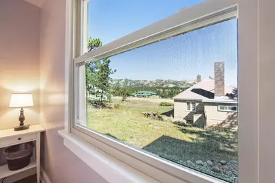 a window in a room with a view of a house at Your Vacation House ---EV#3216 home in Estes Park