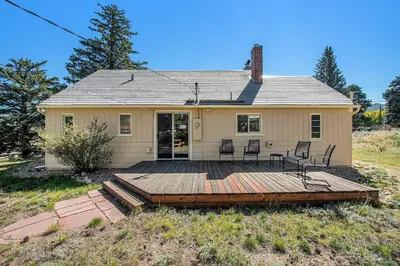 a house with a wooden deck in front of it at Your Vacation House ---EV#3216 home in Estes Park