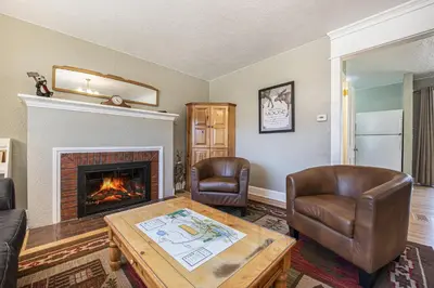 a living room with two chairs and a fireplace at Your Vacation House ---EV#3216 home in Estes Park