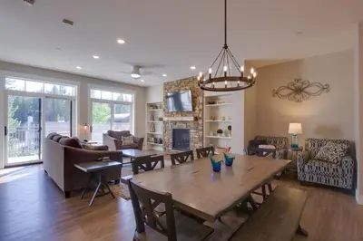 a dining room and living room with a table and chairs at Stunning Winter Park Condo Near Slopes! in Winter Park