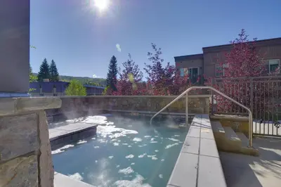 a swimming pool with a hose in the water at Stunning Winter Park Condo Near Slopes! in Winter Park