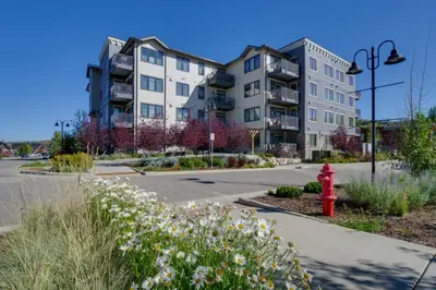 a red fire hydrant in front of a building at Stunning Winter Park Condo Near Slopes! in Winter Park