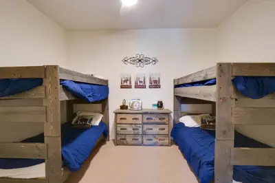 a bedroom with two bunk beds and a desk at Stunning Winter Park Condo Near Slopes! in Winter Park