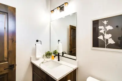 a bathroom with a sink and a mirror at Ski-InandOut Home with Hot Tub in Granby Ranch Resort! in Granby