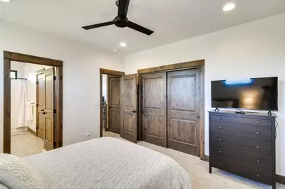 a bedroom with a bed and a flat screen tv at Ski-InandOut Home with Hot Tub in Granby Ranch Resort! in Granby