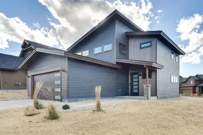 a gray house with a gambrel roof at Ski-InandOut Home with Hot Tub in Granby Ranch Resort! in Granby