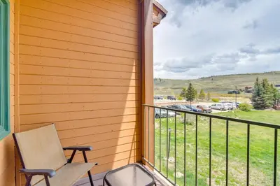a balcony with a chair and a view of a field at 2 Mi to Granby Ranch Mtn Condo with Hot Tub! in Granby