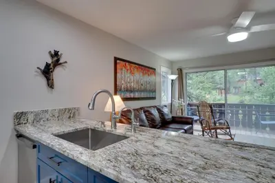 a kitchen with a sink and a living room at Estes Park Vacation Rental 1 Mi to National Park in Estes Park