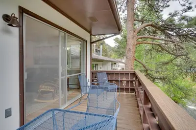 a balcony with two chairs and a tree at Estes Park Vacation Rental 1 Mi to National Park in Estes Park