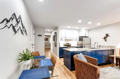 an open kitchen and living room with blue cabinets at Estes Park Vacation Rental 1 Mi to National Park in Estes Park