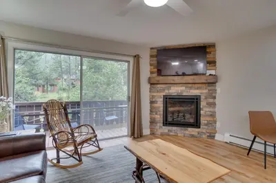 a living room with a fireplace and a tv at Estes Park Vacation Rental 1 Mi to National Park in Estes Park