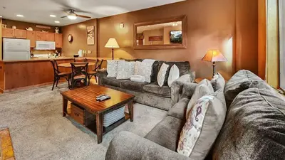 a living room with a couch and a table at Ski in Ski out 1 BDR at River Run Village in Keystone