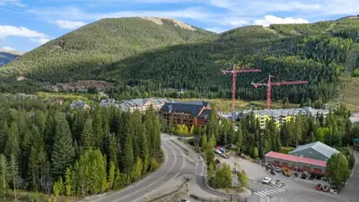 an aerial view of a ski resort with a mountain at Ski in Ski out 1 BDR at River Run Village in Keystone