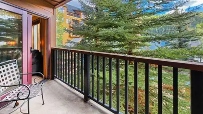 a balcony with a bench and a tree at Ski in Ski out 1 BDR at River Run Village in Keystone