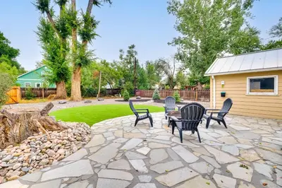 a patio with chairs and a table in a yard at Loveland Retreat with Bicycles, Deck and Fire Pit! in Loveland