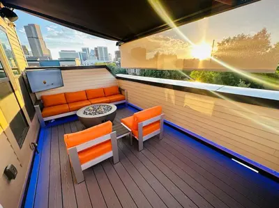 a balcony with orange chairs and a table on a building at Downtown Denver Smart House in Denver