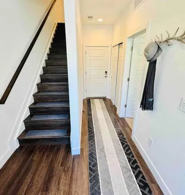 a hallway with a stairway with a stair case at Downtown Denver Smart House in Denver